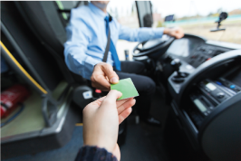 Bus rider handing driver metro card